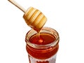 Polyflora bee honey flowing into a jar from a wooden spoon. The concept of beekeeping Royalty Free Stock Photo