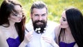 Polygamy relationship. Love triangle. Brutal bearded man with girls.