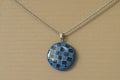 Polymer clay necklace blue and black covered with resin