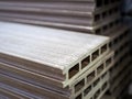 Polymer decking board stacked in a building materials warehouse