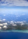 Polynesia. The atoll in ocean through clouds. Aerial view Royalty Free Stock Photo