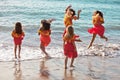 Polynesian Hula girls in jumping in the ocean Royalty Free Stock Photo