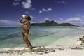 Polynesian man playing shell and ukulele on Bora Bora Island beach and Lagoon - French Polynesia