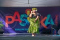 Polynesian woman dancing in front of the logo for Pasifika Festival, Auckland, New Zealand