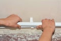 Polypropylene heating pipes installation above the floor as a part of a hydronic radiator heating system. A plumber is installing Royalty Free Stock Photo