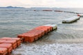 Polystyrene buoy on the sea surface. floating buoys and rope dividing area on the beach. Royalty Free Stock Photo