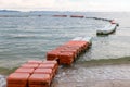 Polystyrene buoy on the sea surface. floating buoys and rope dividing area on the beach. Royalty Free Stock Photo