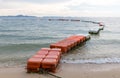 Polystyrene buoy on the sea surface. floating buoys and rope dividing area on the beach. Royalty Free Stock Photo