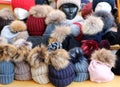 Pom pom beanie, hats for women, on a shelf of a market store