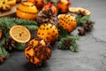Pomander balls made of fresh tangerines with cloves  on dark table, space for text. Christmas atmosphere Royalty Free Stock Photo