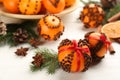 Pomander balls made of fresh tangerines with cloves  on white wooden table. Christmas atmosphere Royalty Free Stock Photo