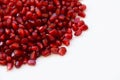 Pomegranat seeds on white background.