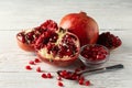 Pomegranate, bowl and spoon on background, close up