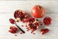 Pomegranate, bowl and spoon on background
