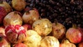 Pomegranate and chestnuts at a street market, one of the fruits is opened up to reveal the pomegranate inside