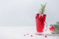 Pomegranate Christmas cocktail with rosemary, champagne, club soda on grey concrete table Royalty Free Stock Photo