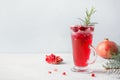 Pomegranate Christmas cocktail with rosemary, champagne, club soda on grey concrete table Royalty Free Stock Photo