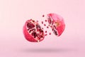 Pomegranate in flight burst. Cut half pomegranate flying in the air. Pomegranate fruit explosion Royalty Free Stock Photo