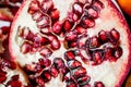 pomegranate fruit cut in half up close on seeds inside