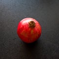 Pomegranate fruit on dark table or kitchen counter Royalty Free Stock Photo