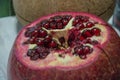 Pomegranate fruit in the foreground, a prize for the palate