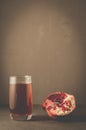 Pomegranate fruit and juice in glass/Pomegranate fruit and juice in glass on dark background with copy space