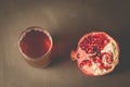 Pomegranate fruit and juice in glass/Pomegranate fruit and juice in glass on dark background, top view