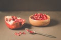 pomegranate fruit, the purified pomegranate seeds in a wooden bowl/Pomegranate fruit and grains in a wooden bowl and a spoon