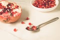 pomegranate fruit, the purified pomegranate seeds in a bowl/pomegranate fruit, the purified pomegranate seeds in a bowl on a white