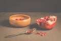 pomegranate fruit, the purified pomegranate seeds in a wooden bowl/Pomegranate fruit and grains in a wooden bowl and a spoon
