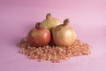 Pomegranate fruit and pomegranate seeds on a pink background Royalty Free Stock Photo