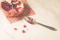 pomegranate fruit and seeds on a white background and in a spoon/pomegranate fruit and seeds on a white background and in a spoon