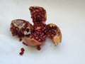 Pomegranate Fruit Sliced into Four Section on white Background