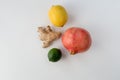 Pomegranate, ginger, lemon, lime on a white background. set against colds, vitamin bomb.