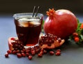 Pomegranate juice, fruit, seeds, branches. Royalty Free Stock Photo