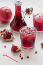 Pomegranate juice in glass with ice and pomegranate fruit Royalty Free Stock Photo