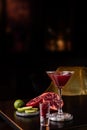 Pomegranate Martini in a night club bar garnished with fruits