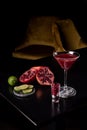 Pomegranate Martini in a night club bar garnished with fruits