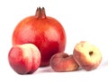 Pomegranate, nectarine and two peaches Royalty Free Stock Photo