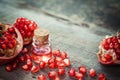 Pomegranate oil in bottle and garnet fruit with seeds