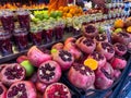 Pomegranate and oranges cut in half on fruit market stall Royalty Free Stock Photo