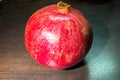 Wholesome ripe pomegranate fruit in red scabrous peel. Royalty Free Stock Photo