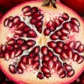Pomegranate (Punica granatum) sliced in half, revealing clusters of ruby-red arils Royalty Free Stock Photo