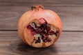 Pomegranate, ripe and cut on a wooden background