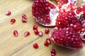 Open pomegranate with peel on a wooden table