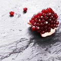 Pomegranate section on wet stone with two seeds Royalty Free Stock Photo