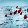 Pomegranate section on wet turquoise stone. Royalty Free Stock Photo