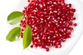 Pomegranate seed pile and green leaves Royalty Free Stock Photo
