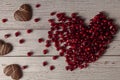 Pomegranate seeds arranged in moving heart shape with a smear of seeds disintegrating as a tail