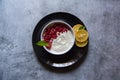 Pomegranate seeds on curd along with fresh fruit ingredients